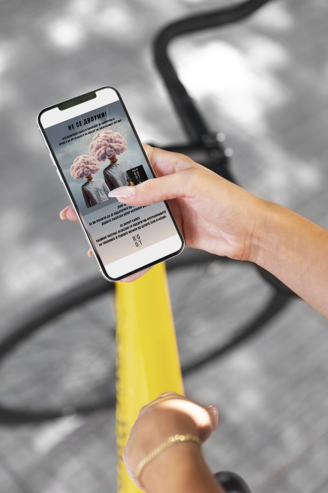 Woman using mock-up smartphone outdoors while on bicycle